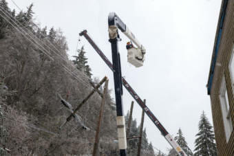 A crew from Alaska Electric Light & Power work on a downed power line on Monday, Nov. 2, 2020 in Juneau, Alaska. Power was out for much of Juneau as morning broke and a storm that had been forecasted to bring rain, instead brought a blizzard. (Photo by Rashah McChesney/KTOO)