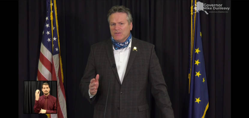 Alaska Gov. Mike Dunleavy appeals to Alaskans to support neighbors, businesses and charities affected by COVID-19 this holiday season. He made the appeal during a news conference, Dec. 15, 2020. A sign language interpreter is on the lower left. (Screen capture of news conference)