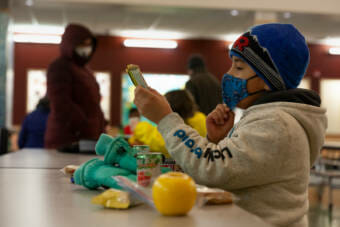Tanner Cooper eyes his lunch at Sayéik Gastineau Community School where he and his sister returned for in-person learning on Thursday, Jan. 14, 2021, in Juneau, Alaska. (Photo by Rashah McChesney/KTOO)