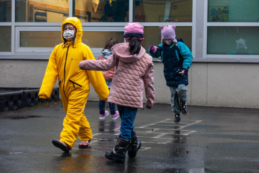 A group of first grade students play on the playground at Sayéik Gastineau Community School on Thursday, Jan. 14, 2021, in Juneau, Alaska. The school resumed in-person classes after spending months doing remote learning because of the COVID-19 pandemic. (Photo by Rashah McChesney/KTOO)