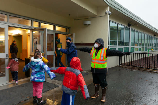 Students at Sayéik Gastineau Community School spread their arms apart to keep socially distanced while standing in line on Thursday, Jan. 14, 2021, in Juneau, Alaska. (Photo by Rashah McChesney/KTOO)