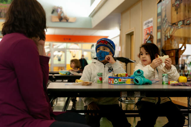 Tanner and Amnara Cooper meet the new principal of Sayéik Gastineau Community School during their first day of in-person classes on Thursday, Jan. 14, 2021, in Juneau, Alaska. (Photo by Rashah McChesney/KTOO)