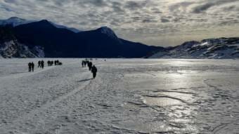 Hikers crossing frozen Mendenhall Lake