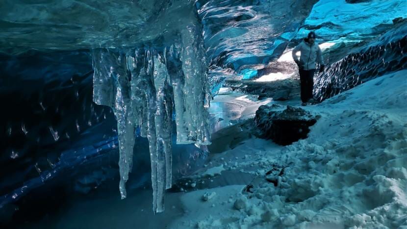 A hiker makes their way out of one of the ice caves at Mendenhall Glacier on Feb. 14, 2021.