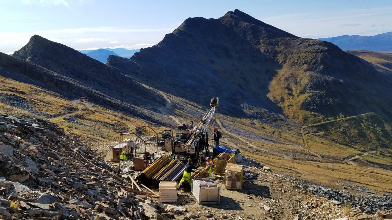 A drill rig in a remote-looking mountain range