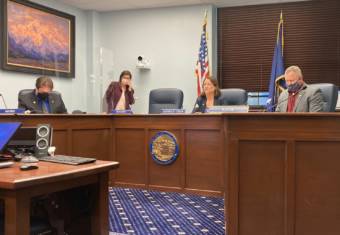 Sen. Robert Myers, R-North Pole; a legislative aide; Sen. Lora Reinbold, R-Eagle River; and Sen. Mike Shower, R-Wasilla, sit in a committee room in the Alaska State Capitol in Juneau on March 10, 2021. Reinbold had just been banned from most areas of the Capitol until she complies with COVID-19 safety rules. (Photo by Andrew Kitchenman/KTOO and Alaska Public Media)