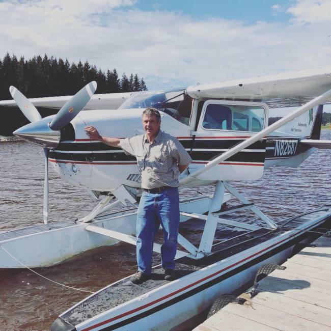 Gary Thompson, who owns Admiralty Air Service, stands in front of one of his planes.