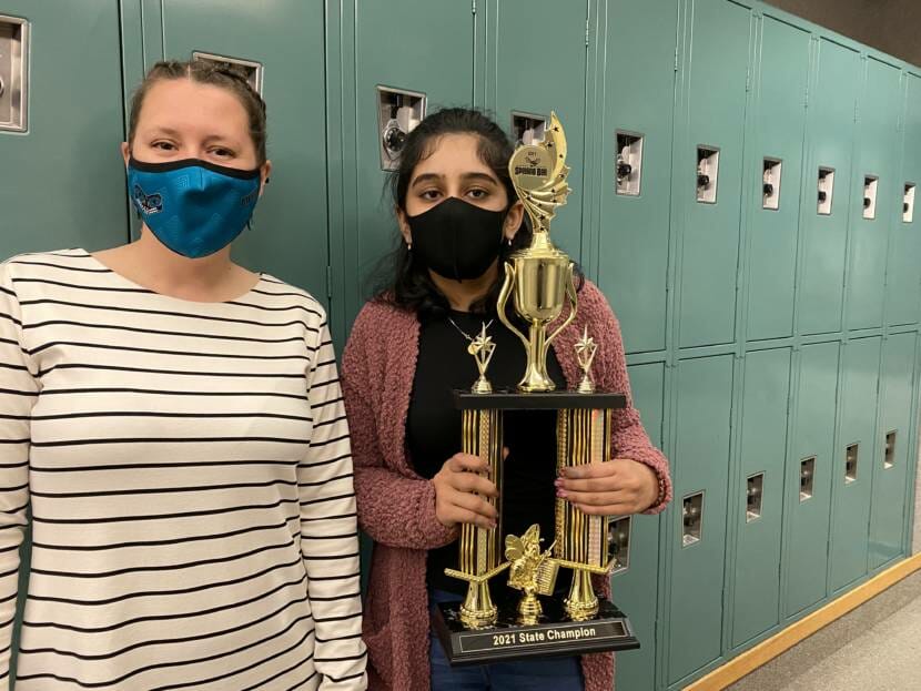 Spelling bee champion, Ishita Khiani (right) poses with her trophy at Dzantik'i Heeni Middle School on Thursday, April 29, 2021. Electra Gardinier (left) is a spelling bee proctor and teacher at DHMS.