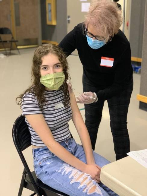15-year-old Carmen Farr receives her COVID-19 vaccine at Juneau-Douglas High School: Yadaa.at Kalé on Friday, May 14. 