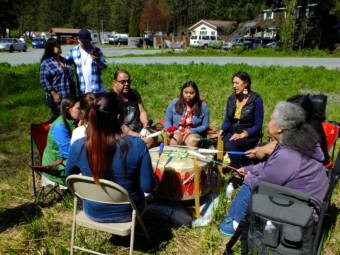 Spirit Lodge Singers use a healing drum to offer songs and prayer for the safety of Geraldine Nelson as the search for her continues around Lemon Creek on Wednesday, May 19, 2021, in Juneau, Alaska. (Photo by Matt Miller/KTOO).