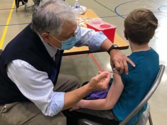 12-year-old Garrett McGuan gets his first dose of the COVID1-9 vaccine at Dzantik'i Heeni Middle School on Monday, May 17.