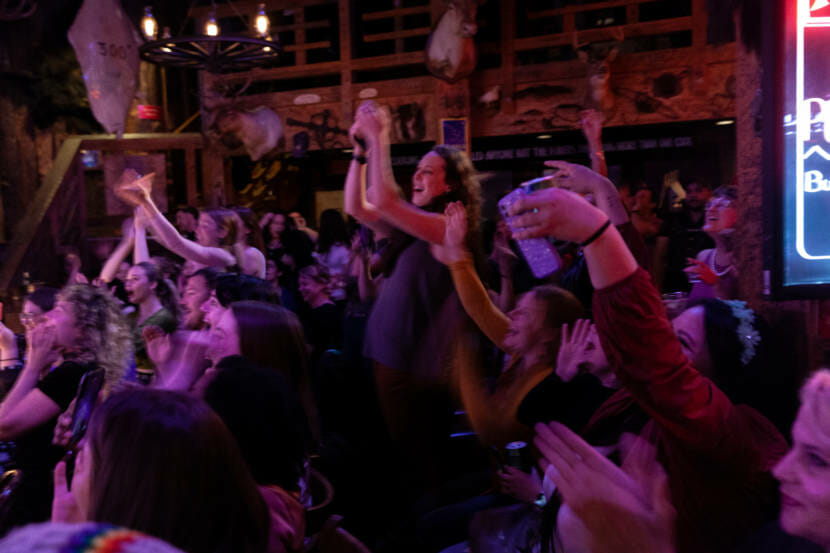 Audience members packed in together to cheer on Juneau Drag queens and kings on Saturday, May 22, 2021, in Juneau, Alaska. It was the troupe's first in-person, performance and they required audience members and Red Dog Saloon staff members to provide proof of full vaccination to attend. (Photo by Rashah McChesney/KTOO)