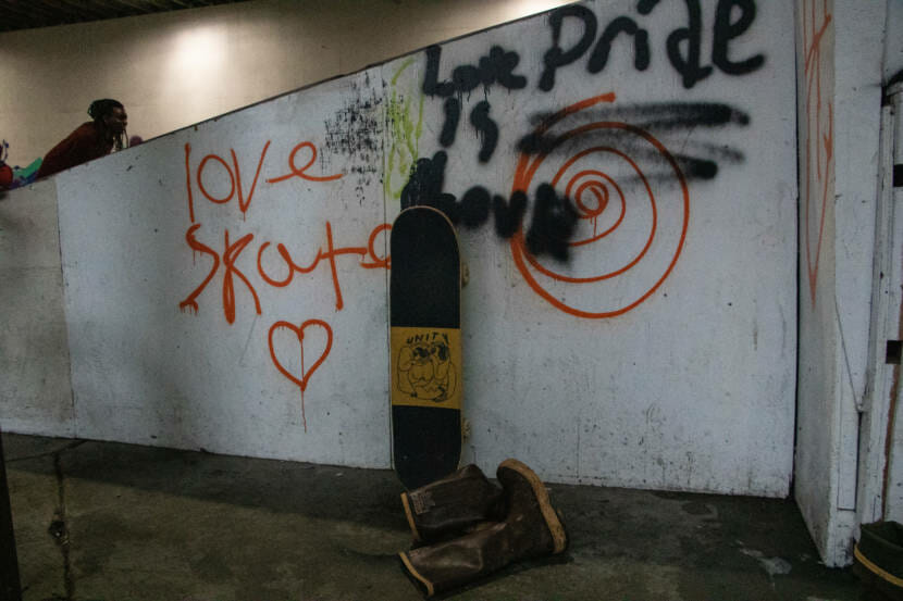 Skateboard and Xtratufs on the side of the Pipeline, the skate park in Juneau.