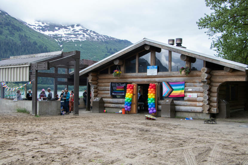 People gather around a shelter at Sandy Beach for a Pride picnic on May 11. The picnic is an annual event that Juneau's LGBTQ+ alliance group SEAGLA sponsors.