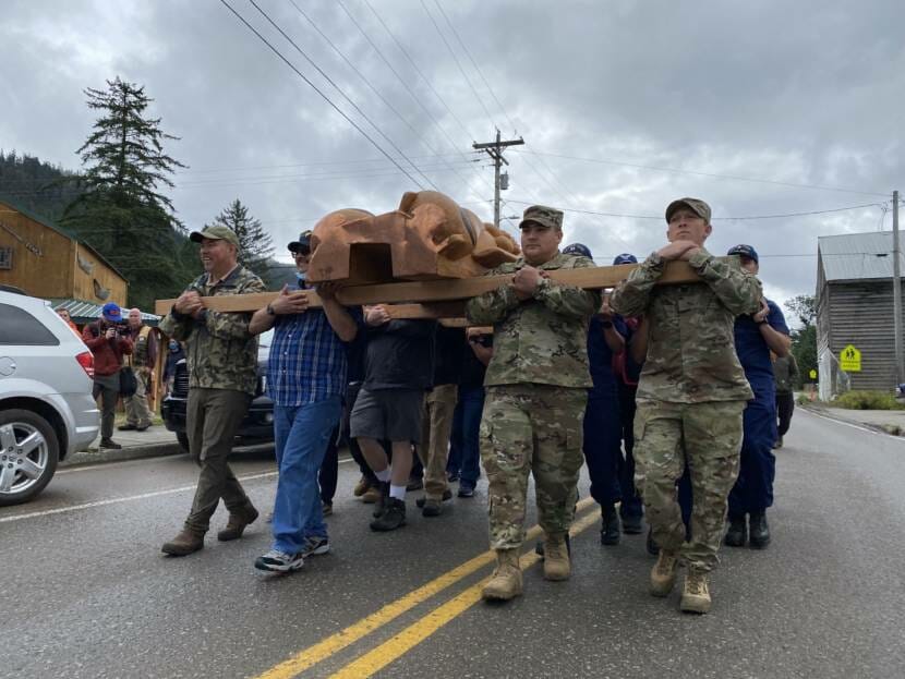 Veterans carry a totem pole to its permanent location in Hoonah. The pole was raised during a ceremony on Saturday July 24. 