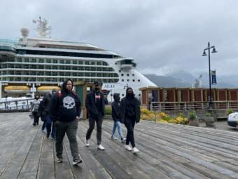 People walk on the dock in front of Royal Caribbean’s Serenade of the Seas. The ship docked in Juneau on July 23, 2021.