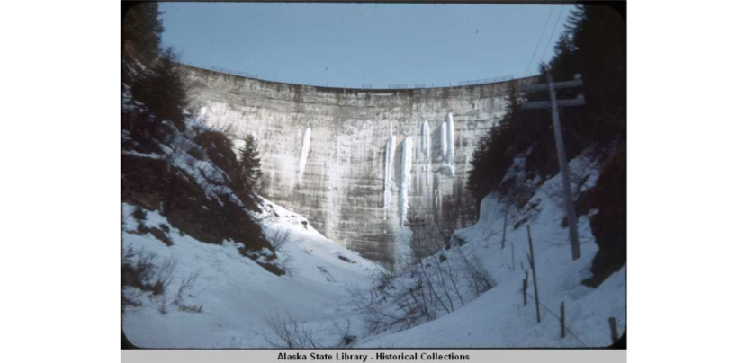 The Salmon Creek Dam, designed by Lars Jorgensen, chief engineer Harry L. Wallenerg, was the first true constant-angle arch dam. It is 168 feet high and 648 feet across. Completed in 1914. Alaska Electric Light and Power Company acquired the Alaska - Juneau Gold Mining Company properties. Photo courtesy Caroline Jensen and the Alaska State Library)