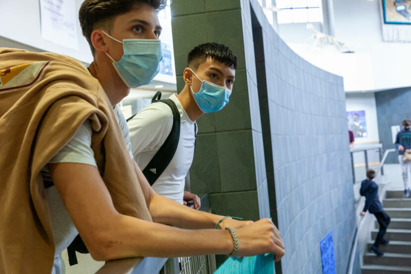 Thunder Mountain High School seniors Kafoa Maka and Ammon Kawakami watch students head to lunch on the first day of school on Monday, August 16, 2021, in Juneau, Alaska. (Photo by Rashah McChesney/KTOO)