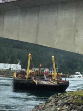 A tugboat hauling a barge with construction equipment in Juneau’s Gastineau Channel lost control on Wednesday, August 25, 2021, hitting the Douglas Bridge. (Photo courtesy Terry Tavel) 