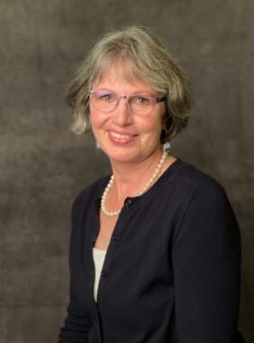 Kathy Callahan, Bartlett Regional Hospital's interim CEO, poses in front of a brown background