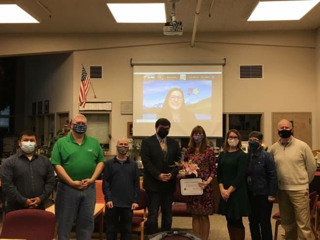 Juneau School District Superintendent Bridget Weiss poses with school board members during a meeting on Tuesday, Sept. 14, 2021. Lisa Parady with the Alaska Superintendents Association showed up via Zoom to present Weiss with an award. 