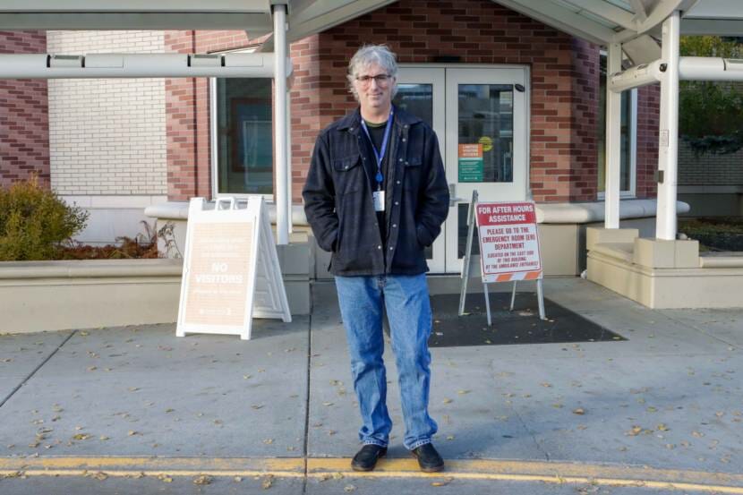 A doctor standing at the entrance to the Alaska Native Medical Center in Anchorage