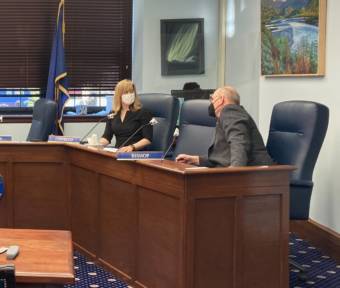 Sen. Mia Costello, R-Anchorage, and Sen. Click Bishop, R-Fairbanks, talk before a Committee on Committee meeting on April 19, 2021, in the Alaska State Capitol in Juneau, Alaska. (Photo by Andrew Kitchenman)
