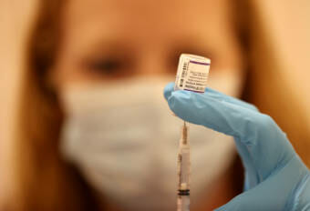 A health care worker holding a needle