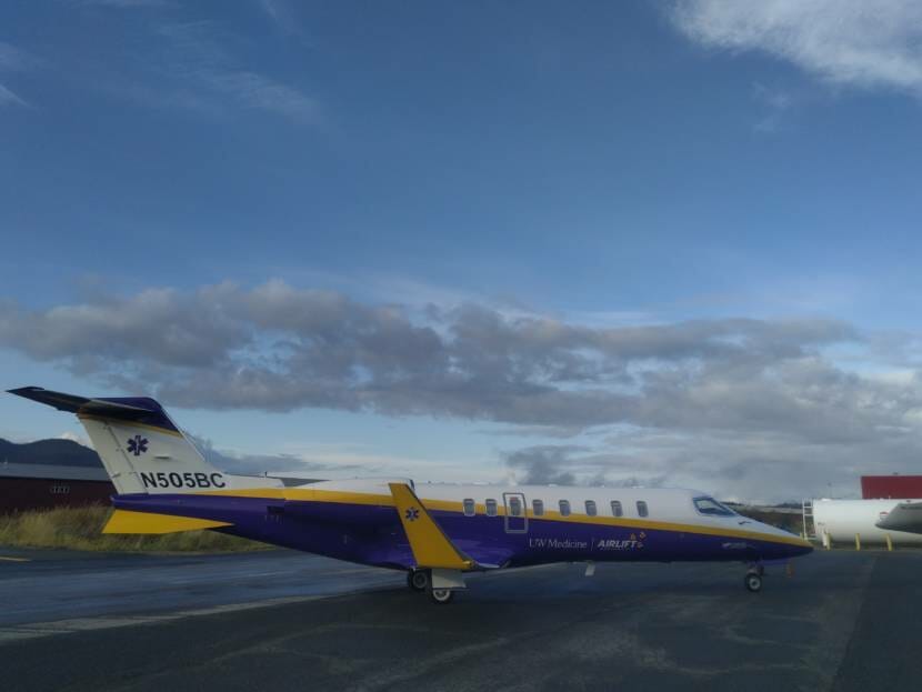 side view of a lear jet sitting on a runway