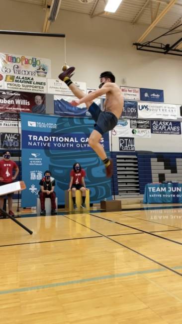 An athlete participates in the One-Foot High Kick during the 2021 Traditional Games in Juneau. 