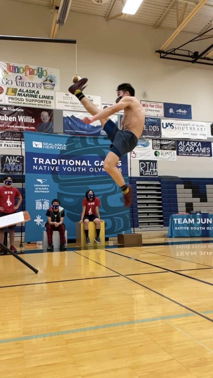 An athlete participates in the One-Foot High Kick during the 2021 Traditional Games in Juneau.