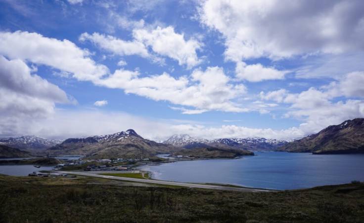 A view of the single-runway Unalaska airport with Dutch Harbor behind it.