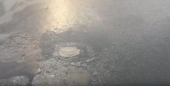 An aerial photo of gas bubbling up in icy water