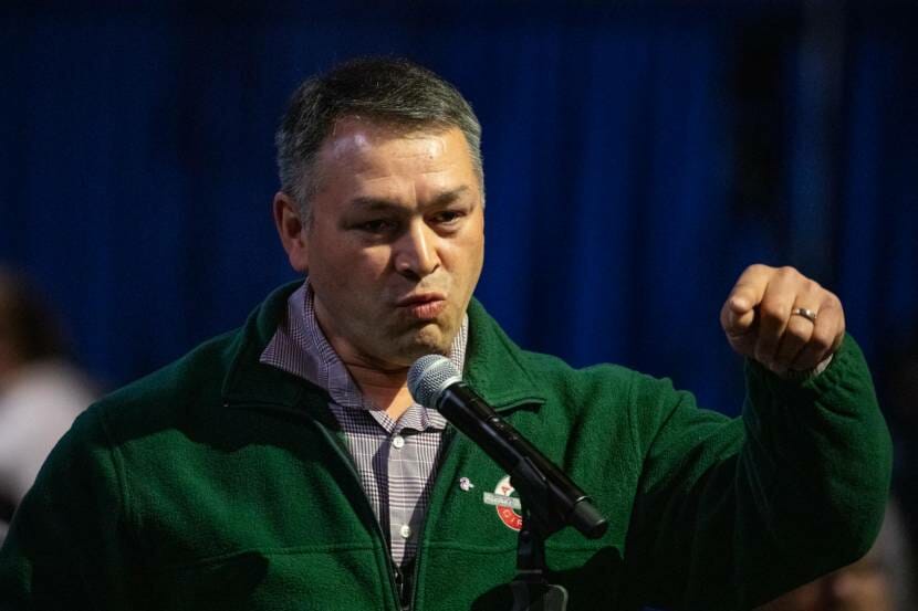 A man gesturing while giving a speech