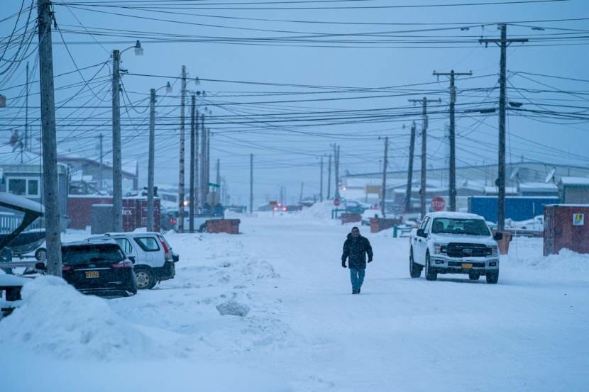 A man walking down a snow-covered street