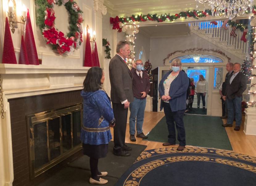 Gov. Mike Dunleavy and Juneau Mayor Beth Weldon speak just before the governor's holiday open house began on Dec. 7, 2021, at the Governor's Mansion in Juneau. Alaska First Lady Rose Dunleavy is on the left. It was the first open house in two years, due to the pandemic. (Photo by Andrew Kitchenman/KTOO and Alaska Public Media)