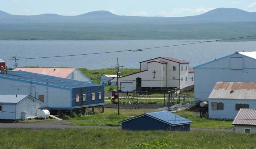 Homes and a church in St. Michael, Alaska, with the bay in the background
