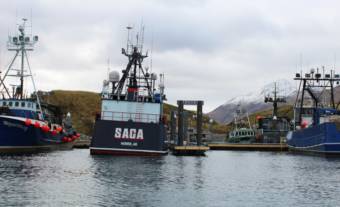 A fishing boat, the Saga, moored alongside others in Dutch Harbor