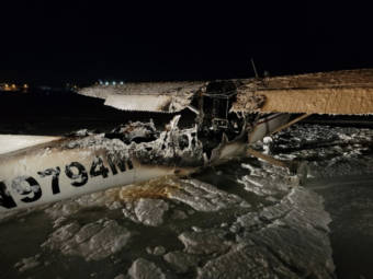 A night photo of an airplane with burnt-out fuselage