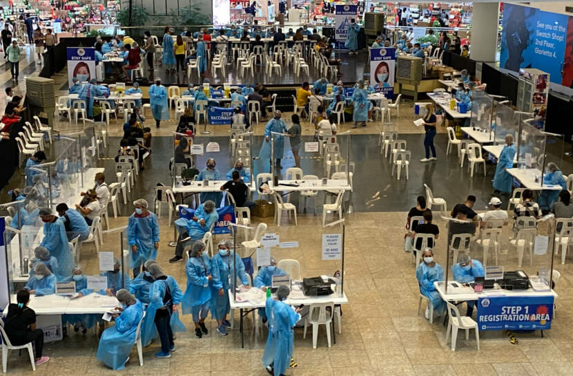 A photo taken looking down on a mass vaccine clinic set up inside a mall.