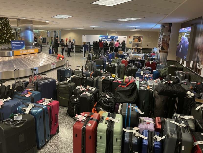 A baggage claim area filled with unclaimed bags