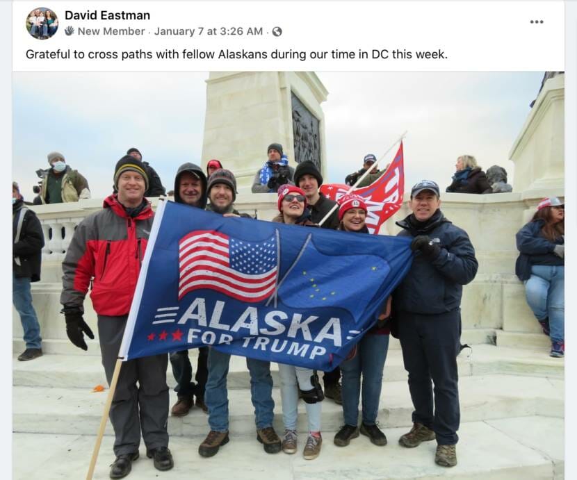 A screenshot of a social media post by David Eastman showing him posing with others holding a Trump flag. The post reads "Grateful to cross paths with fellow Alaskans during our time in DC this week."
