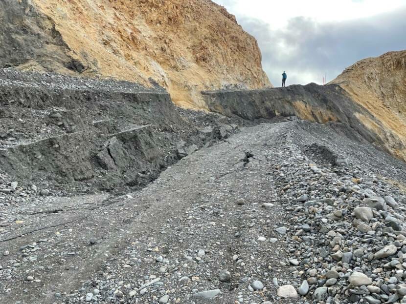 A slumping section of a gravel mountainside road