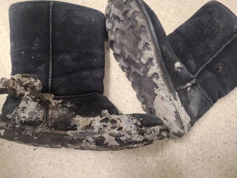 A pair of black winter boots with partially melted soles