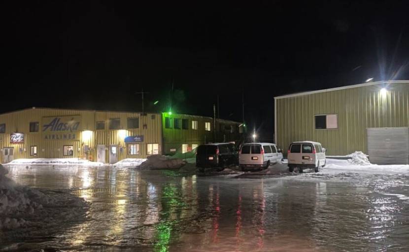 In airport parking lot at night, covered with thick ice