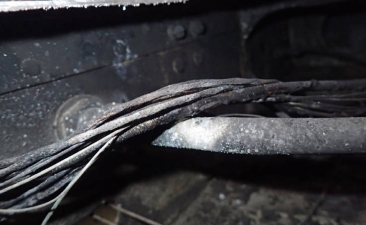 A bundle of wires passing over a fuel line