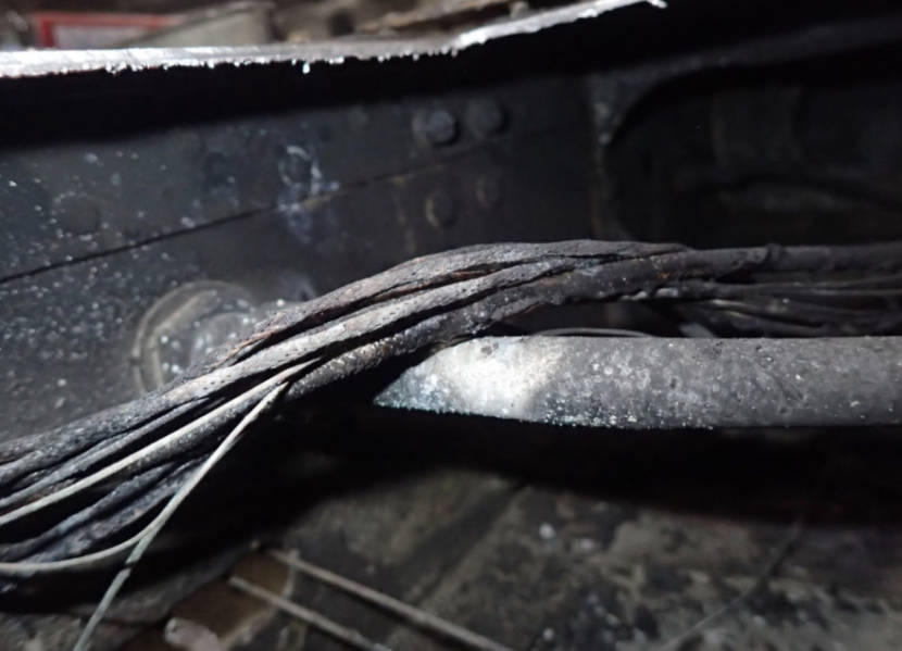 A bundle of wires passing over a fuel line