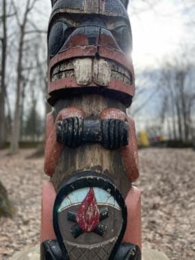 A detail of the totem pole, showing a camp fire