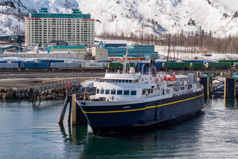 An Alaska state ferry with Whittier in the background