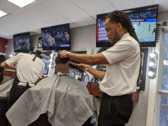 A man cutting hair in a barber shop